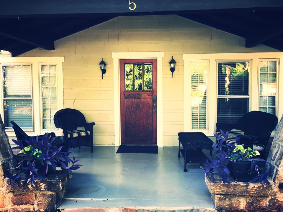 The quaint front porch is a short walk to Main Street/Downtown Greenville! 