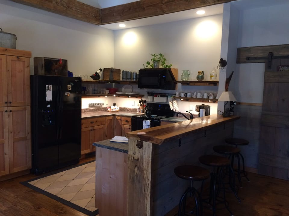 Full kitchen with refrigerator, microwave, range and dishwasher