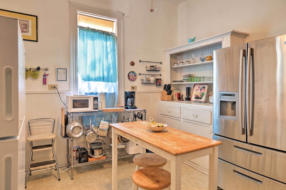 This adorable kitchen is sufficiently stocked with a variety of dishware.