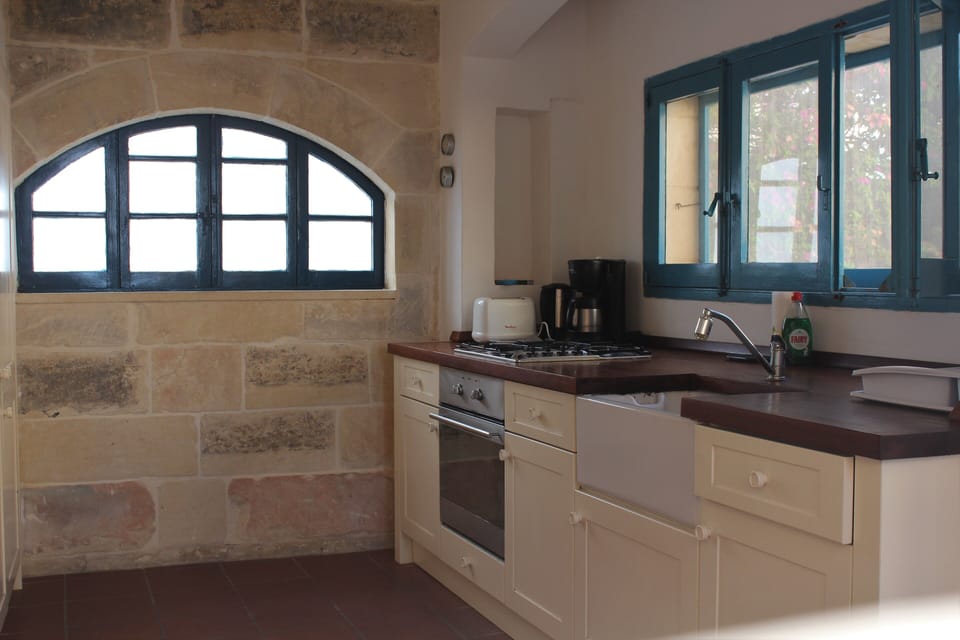 Kitchen with modern age commodities overlooking herb yard and views 