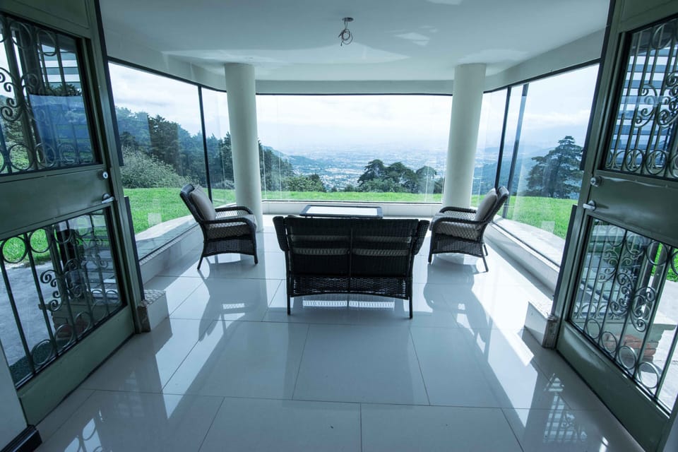 The front porch is glassed in and provides a wonderful view for the sitting area