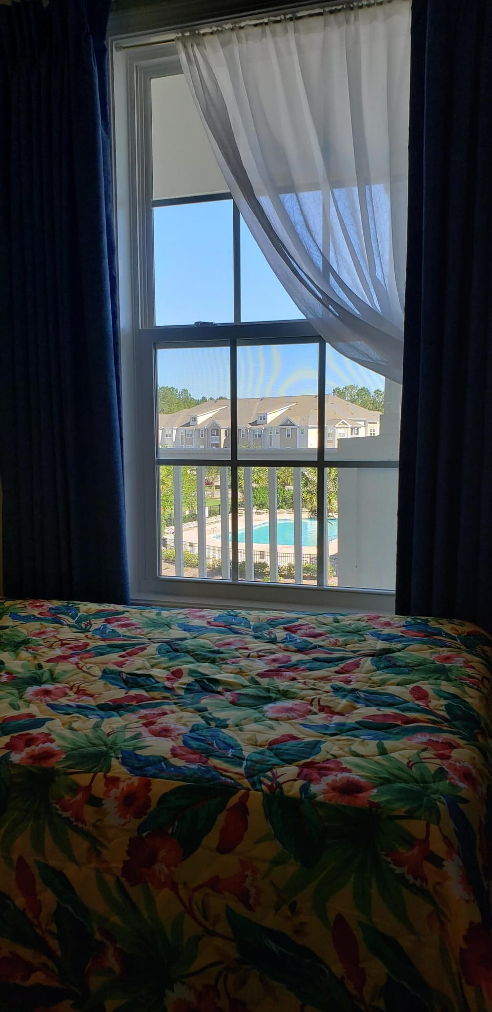 Guest bedroom  w/ view of pool.  2 twin beds, closet and TV.