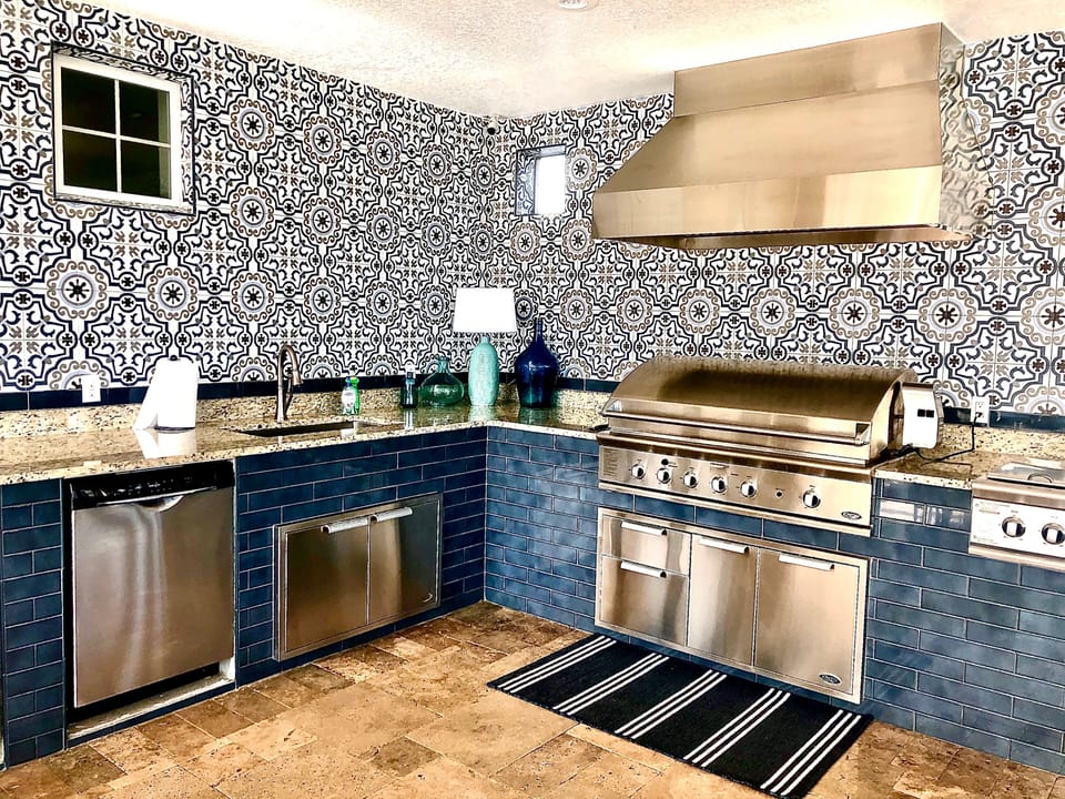 Features a full size grill, dishwasher, fridge with freezer and sink.