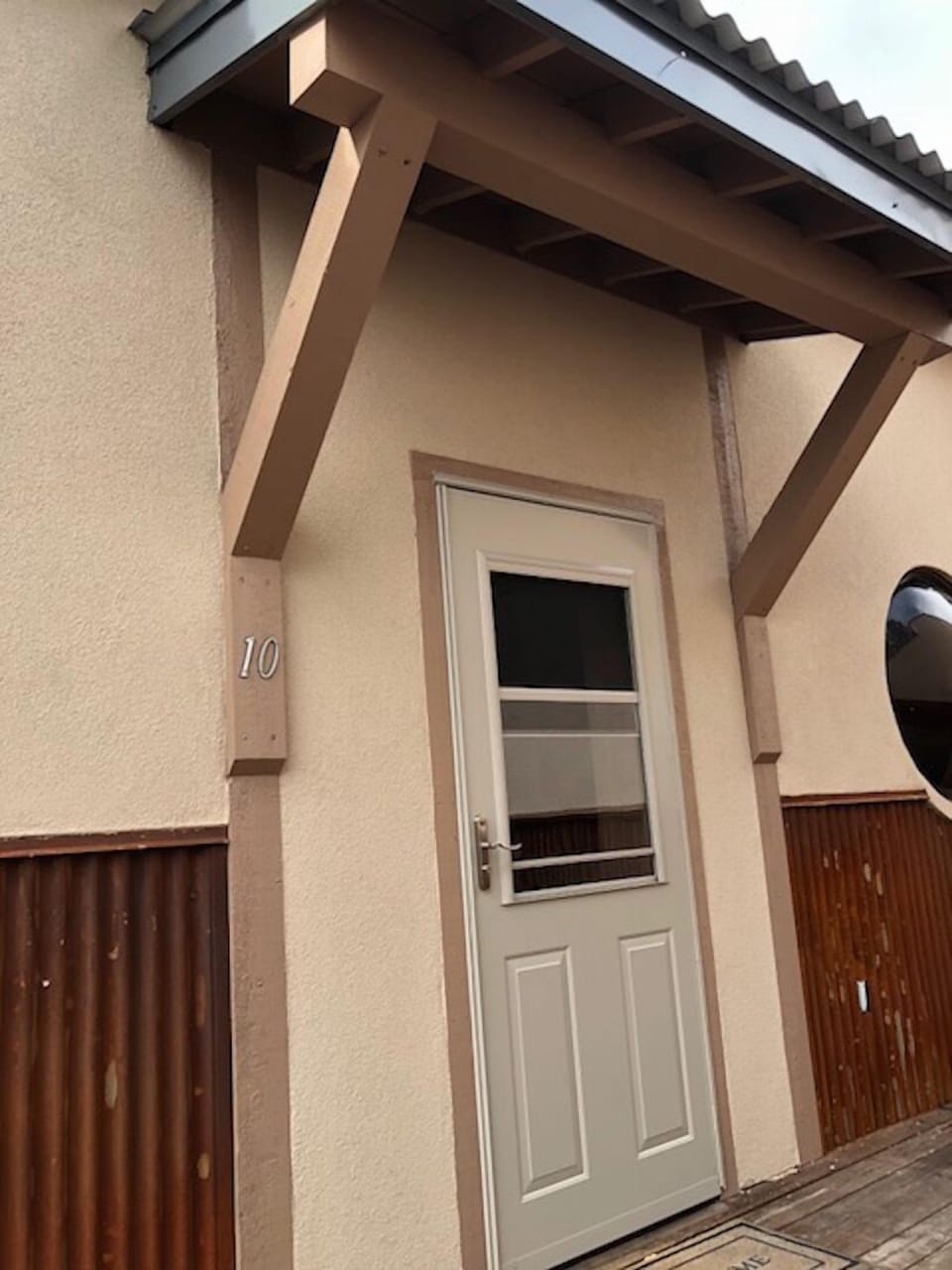 Entrance to condo.  Storm door and mudroom.