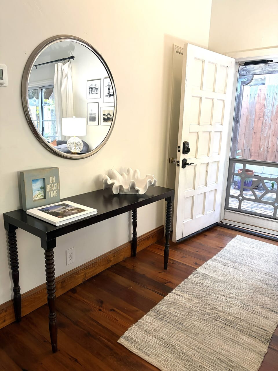 The front entryway has been updated with a glass paneled blue door. 