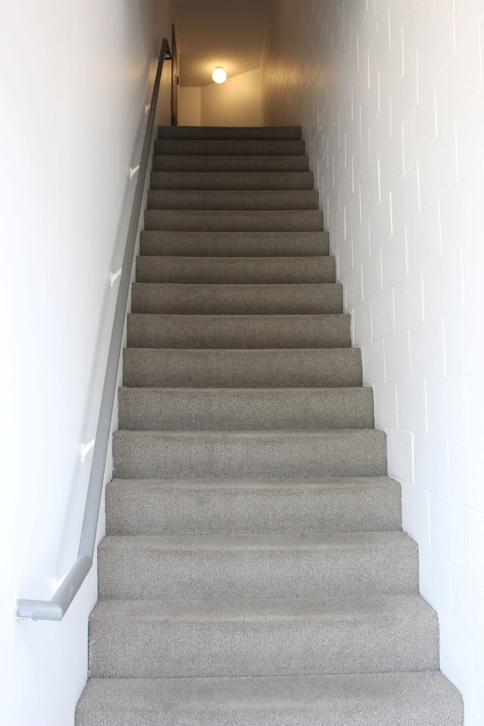 Stairs leading to the apartment from the on-site parking.
