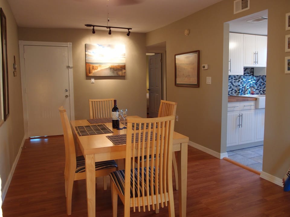 Dining room and kitchen. The back door on the right leads into bedroom.