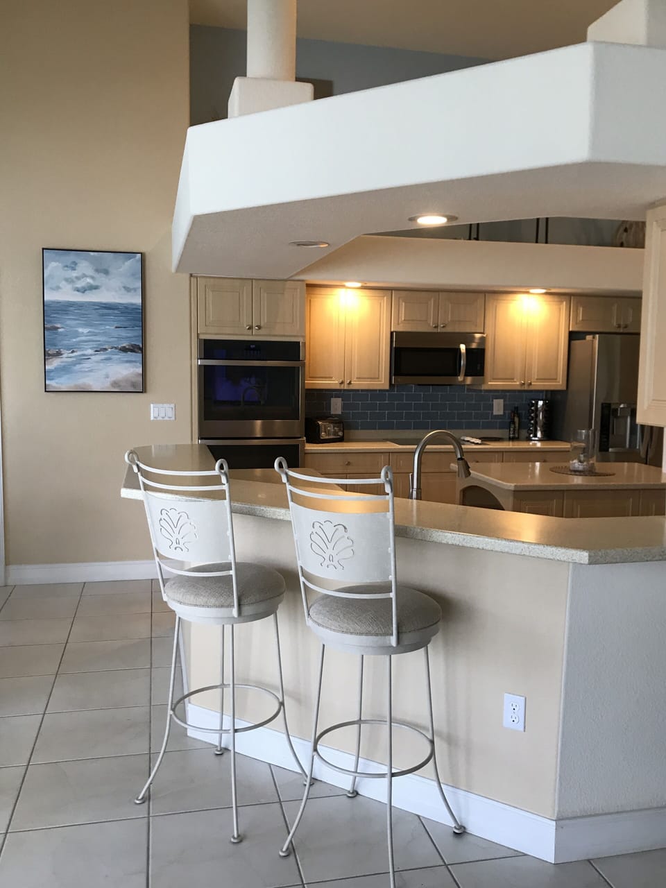 Kitchen has stainless steel double ovens.