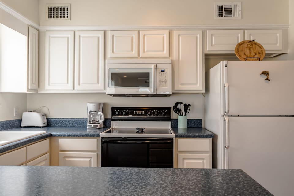 Kitchen has utensils, plates, glasses, pots and pans. We've added a duel Keurig