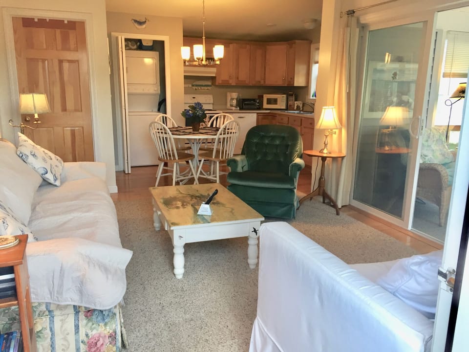 White Sofa bed double,  long couch, swivel green chair TV. A/C Ceiling Fan