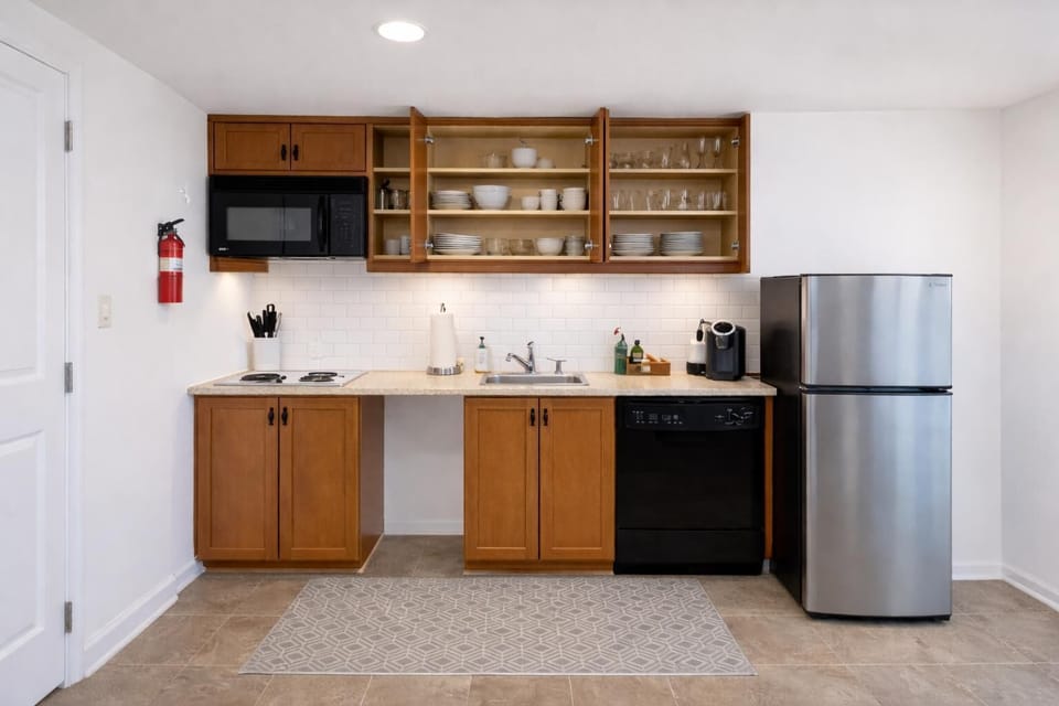 Cozy kitchenette with modern appliances and cookware