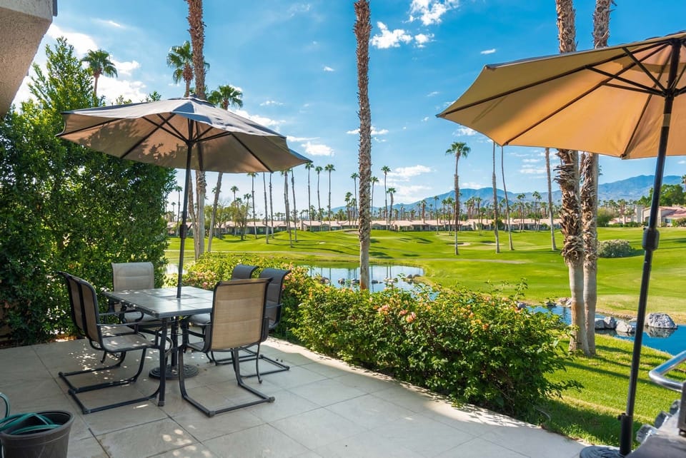 Patio with view of golf course and mountains.