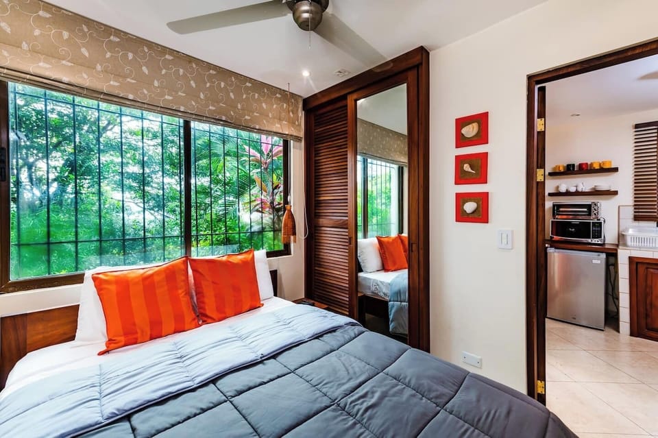 Third bedroom with a queen bed, located beside the main house, featuring its own private kitchen for independent stays in Tamarindo.