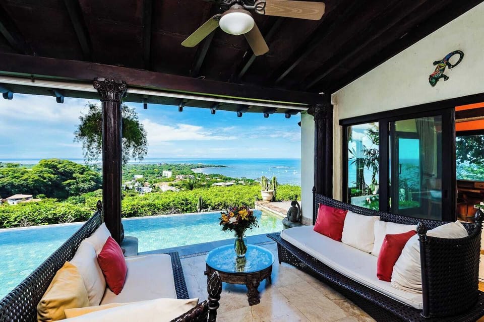 Chill on the outdoor terrace with a comfortable sofa and coffee table, enjoying the tropical ambiance of your Tamarindo getaway.