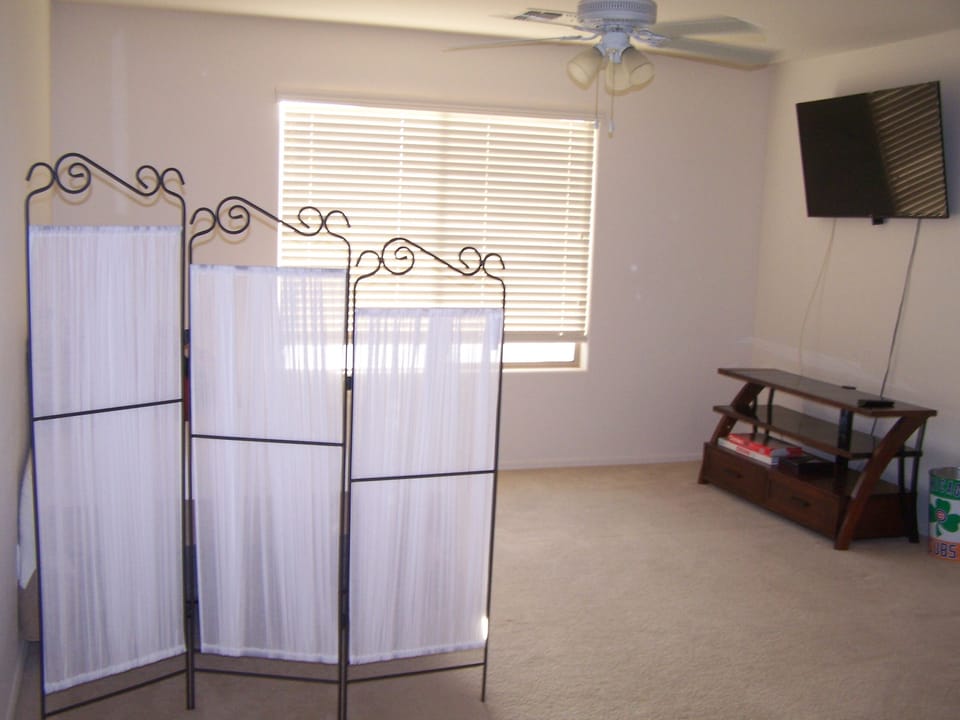 Privacy screen around double bed in loft area.