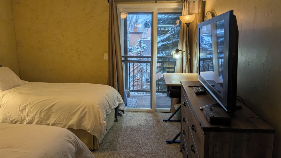 Bedroom 2: Enjoy a peaceful view of the patio from this cozy room.