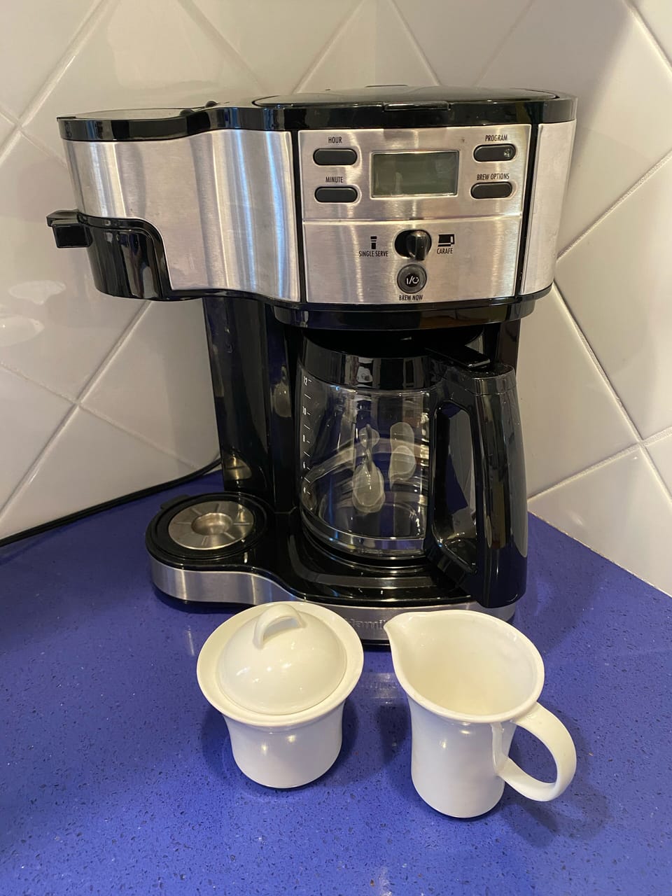 Coffeemaker makes single cup or pot and has reusable filters 
