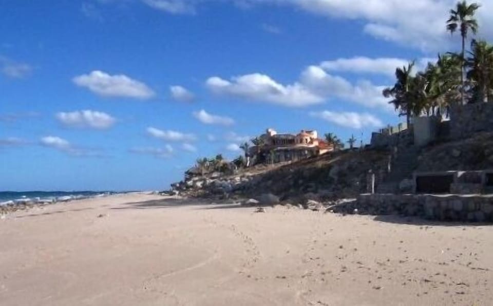 The sandy beach in front of the house