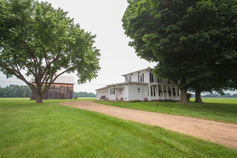 Farmhouse and view of property. 