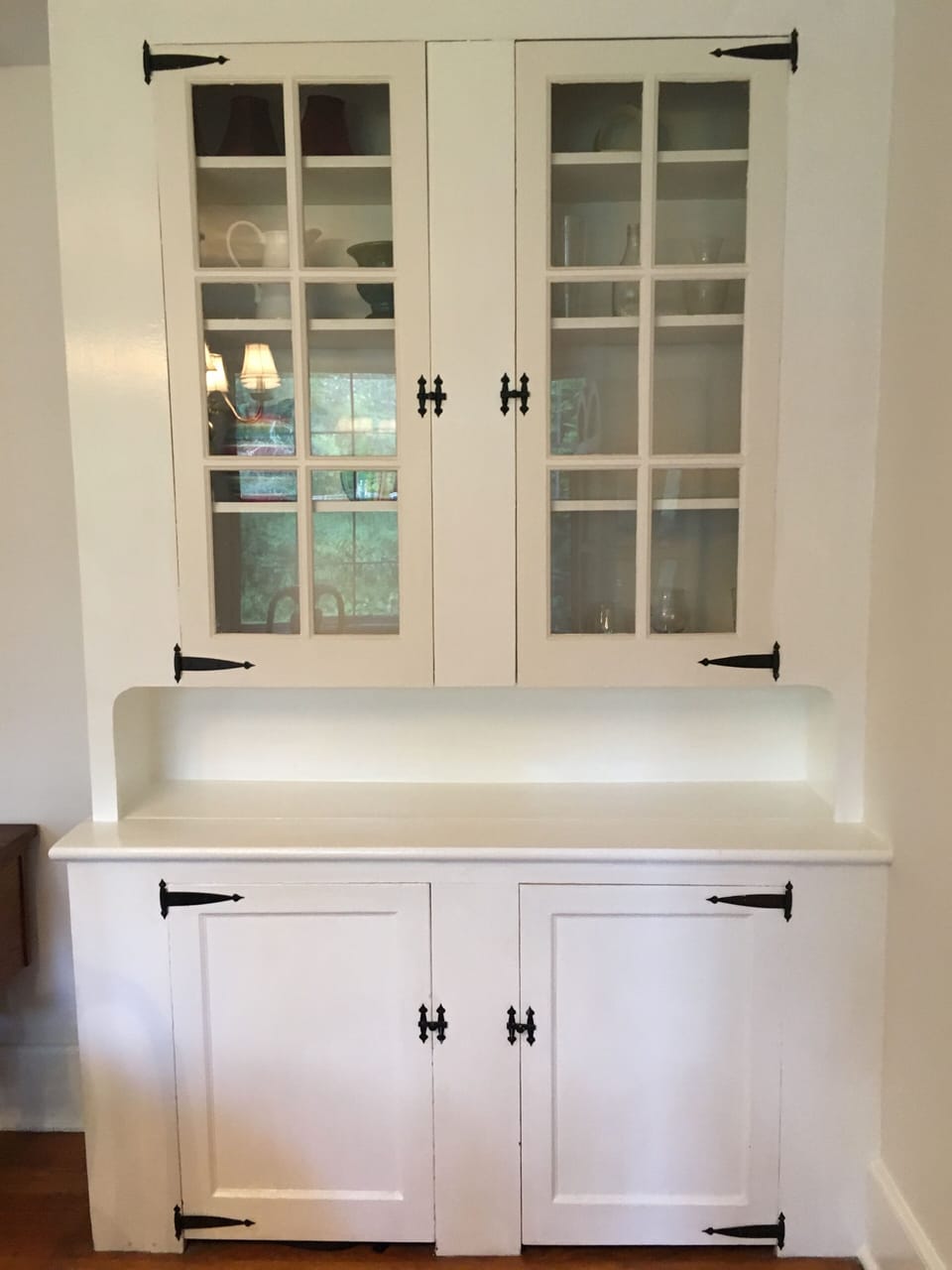 built in bar with glassware and cocktail shaker