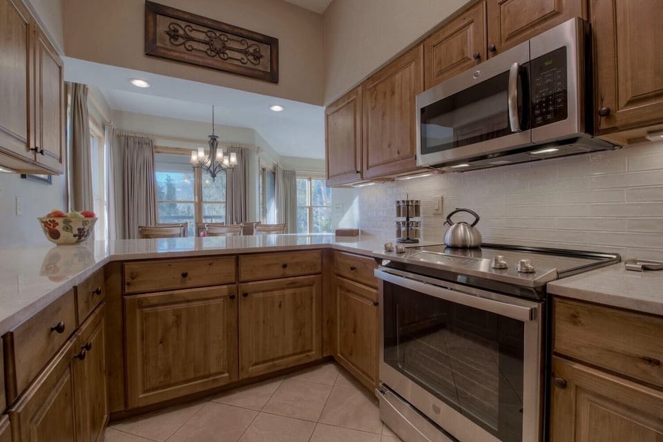 Kitchen with quartzite countertops and new stove.