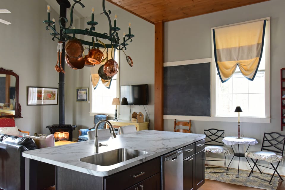 Schoolhouse chalkboard retained with origanal six foot windows view of brook.