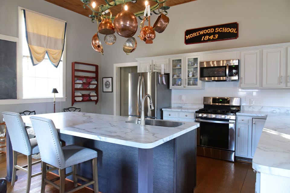 Custom island for dining and preparing meals in a well equiped kitchen.