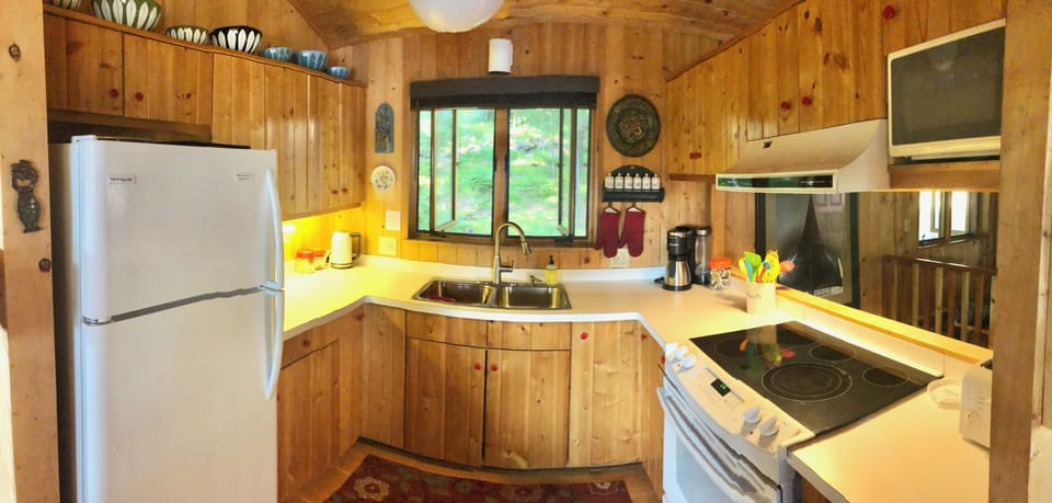 Fully stocked kitchen with views of the lake while cooking