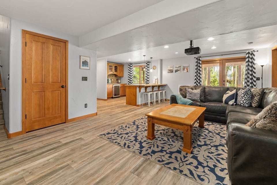 Our spacious den includes a large sectional, projector TV and kitchenette