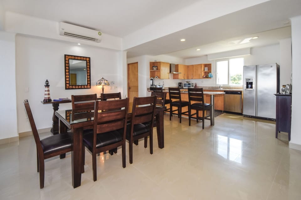 Dining room with kitchen island.  Enjoy the beautiful views while eating.
