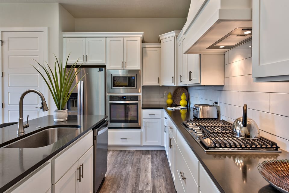 Side View Of Kitchen - Side view of kitchen showing off the beautiful counter tops and stainless steel appliances.