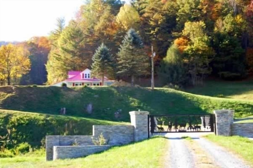 Gated entrance to private 27 acre farm and a view of the Red Roof Farmhouse.