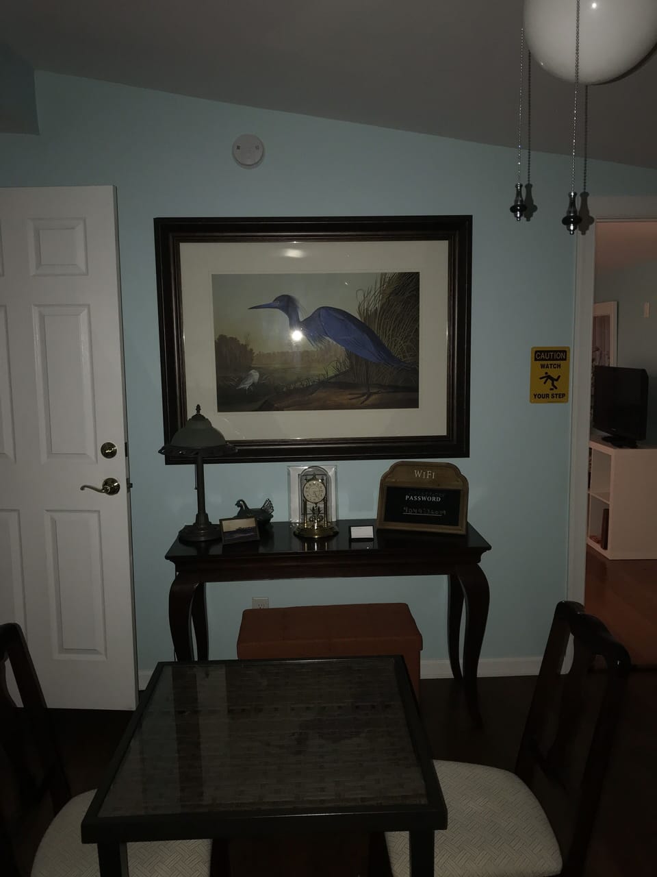 Living room equipped with a large TV, stereo and Alexa.