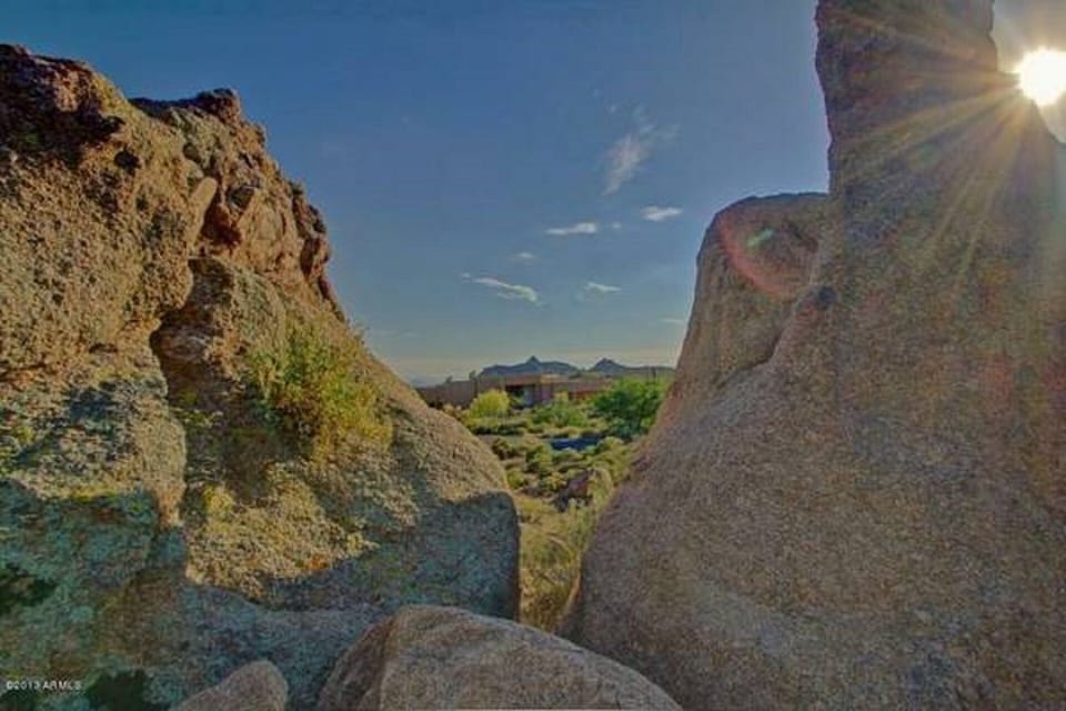 View from the mountain in between large natural boulders.