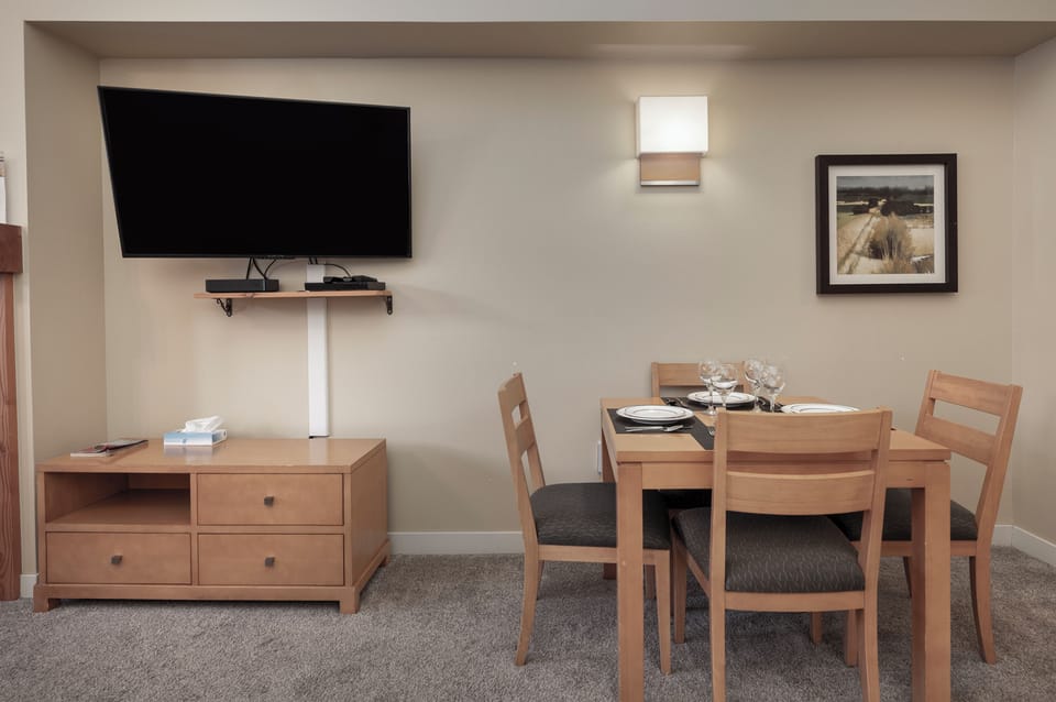 Enjoy meals together at your own dining table while catching up on shows on the large flat-screen TV in this comfortable living space.