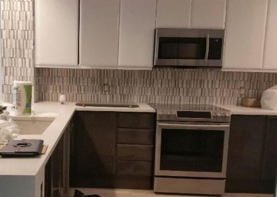 Your  white Quartz counters and Upscale Appliances make this a showroom kitchen 