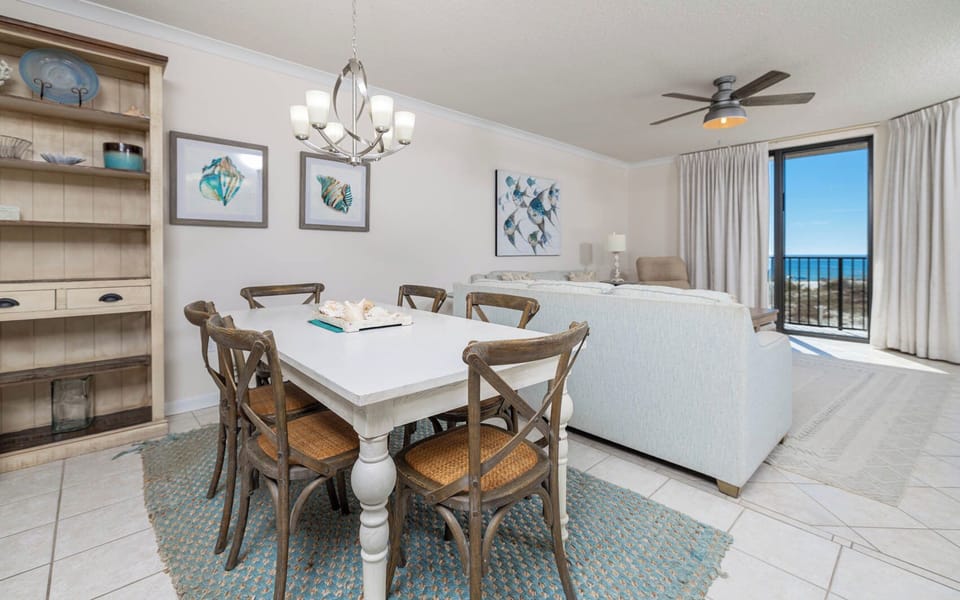Dine at the stylish table while enjoying the inviting decor and beach views from the large windows in this spacious area