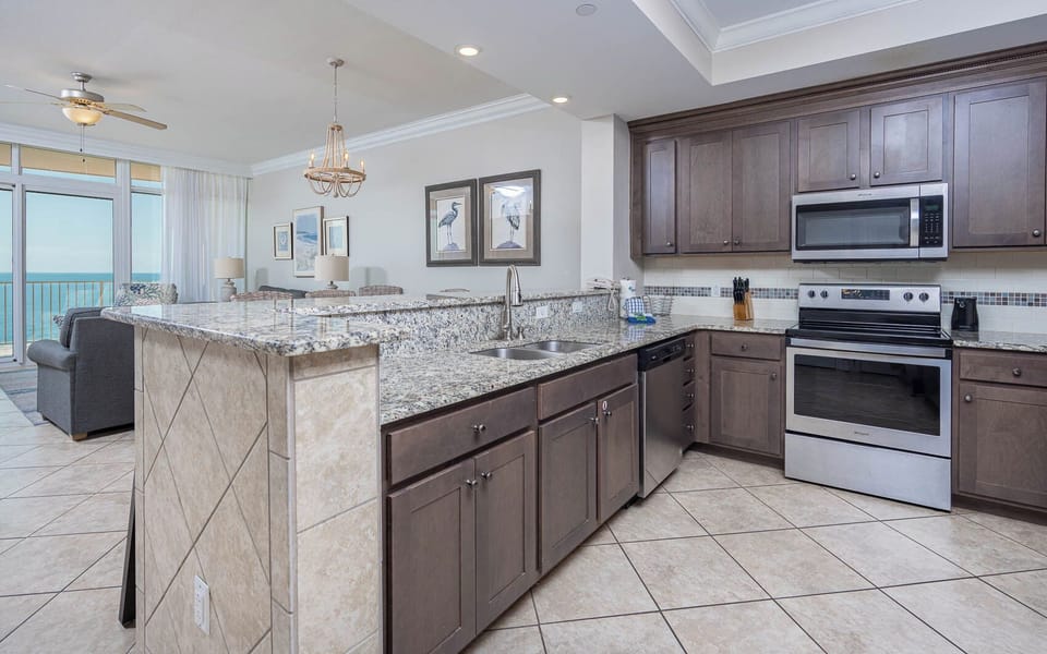 Prepare meals in this kitchen with elegant cabinetry, stainless appliances, and stylish backsplash