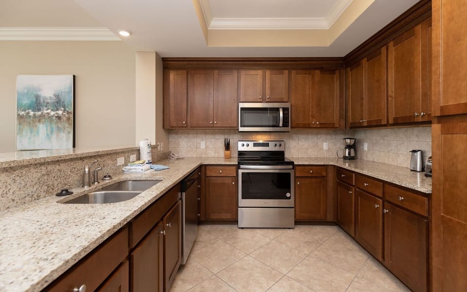 Prepare meals in this kitchen with elegant cabinetry, stainless appliances, and spacious countertops