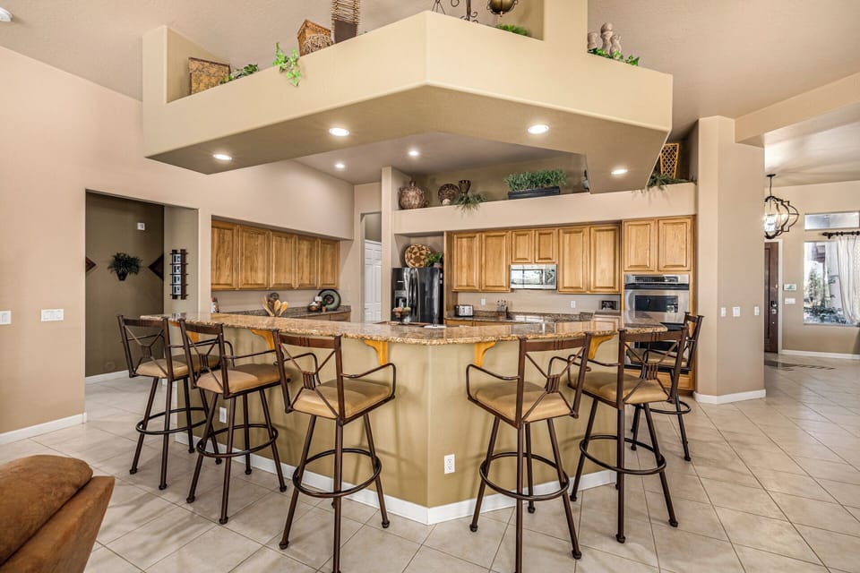 Seating for 6 at kitchen counter. Hall leads to Bedrooms 2 & 3