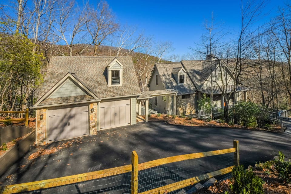 Full home view, garage in foreground, house at right.