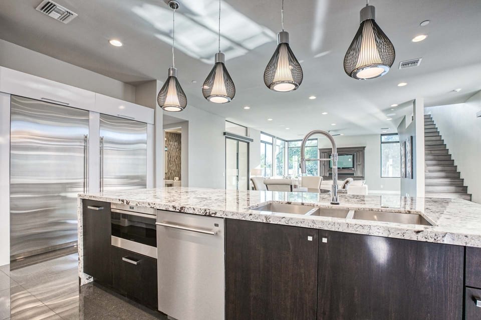 Large island w/ waterfall countertops, oversized sink, dishwasher, & microwave 