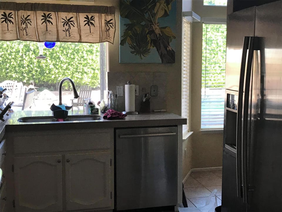 Kitchen with new counters in quartz with new spout faucet and lovely pool view.