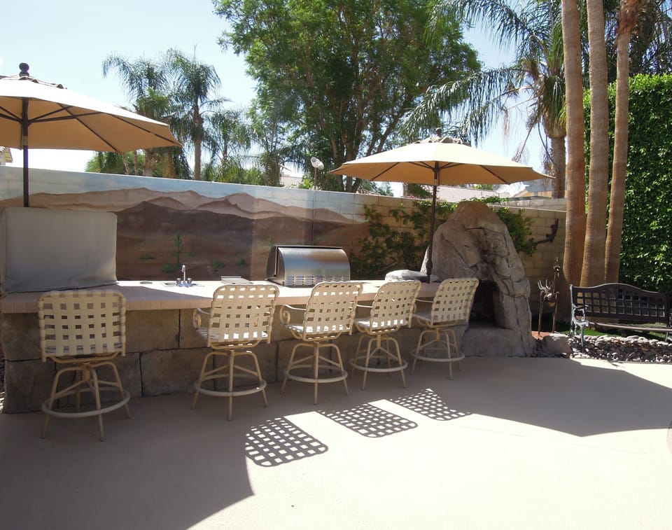 Entertainment area with flat screen TV, BBQ, gas grill, sink and fireplace