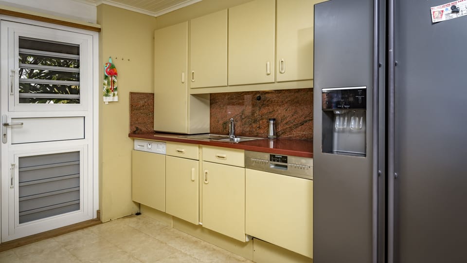 Kitchen with a shutter door and screens.