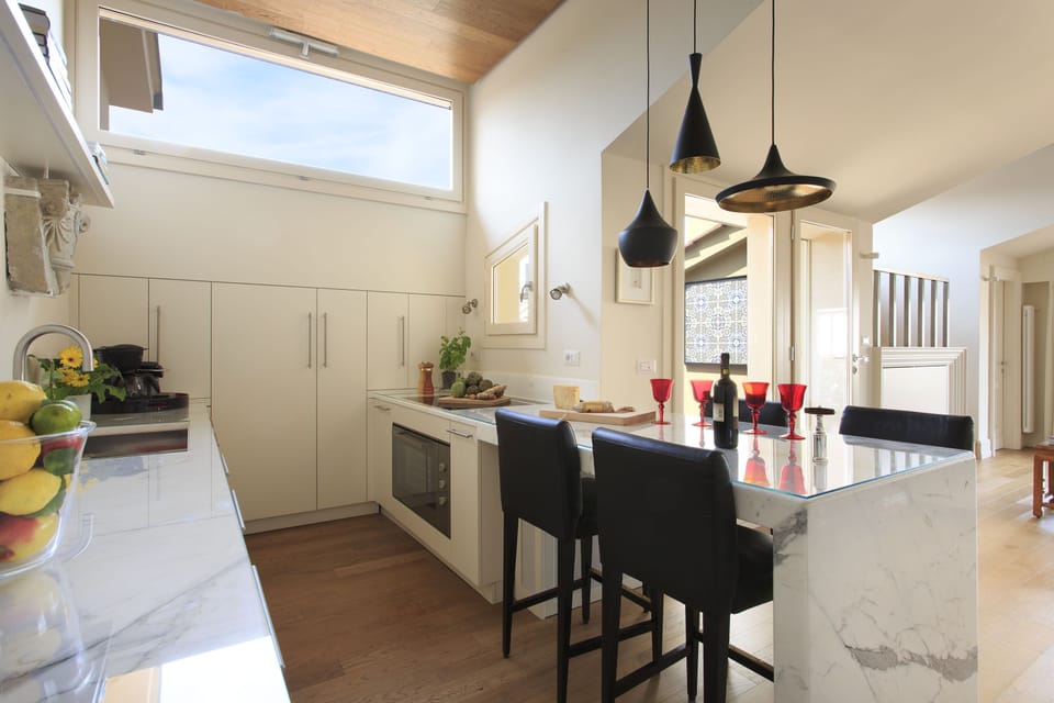 Fully equipped Carrara marble kitchen. View onto terraces.