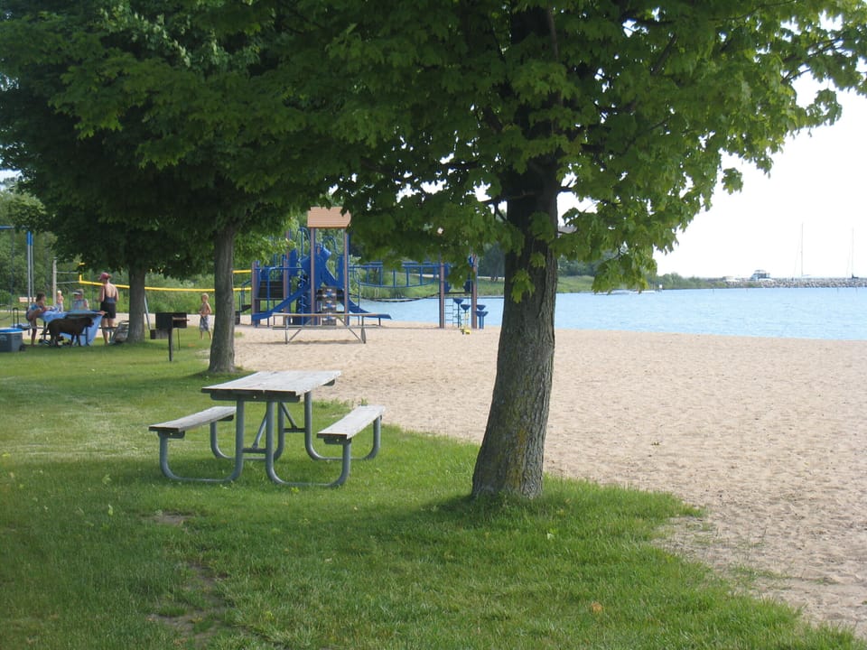 Suttons Bay beach is perfect for kids with playground, swings and picnic tables