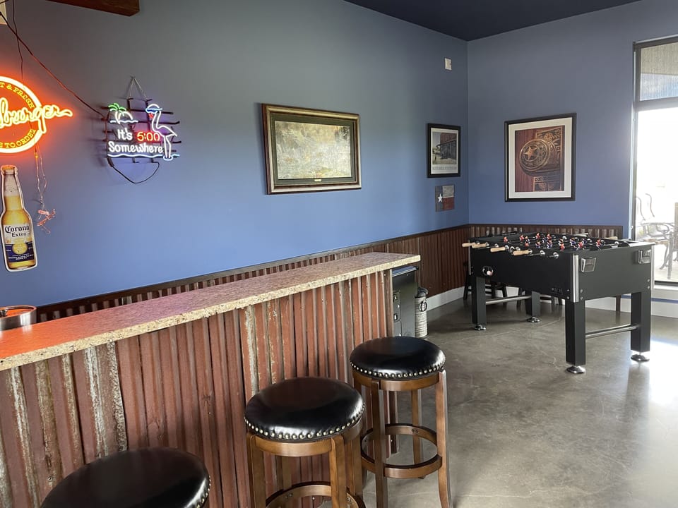 Foosball and electronic game table, also card table, sofas and TV