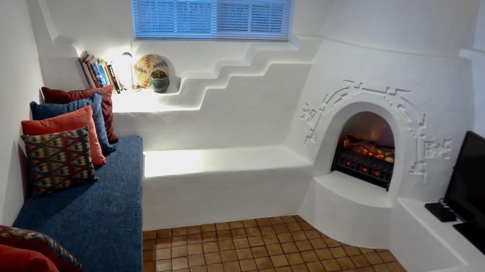 Sunken living room fireplace  electric insert providing  illumination and heat