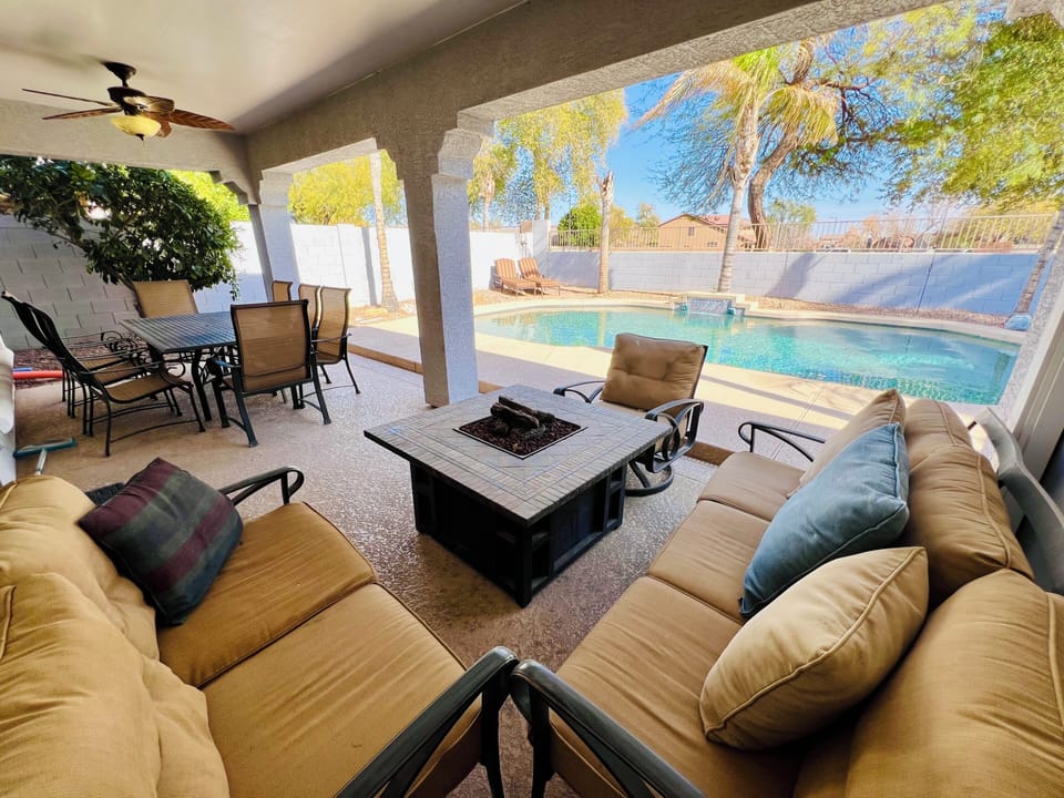 Outdoor shaded dining table for 8 and seating area around the fireplace 